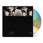 A black music album case with a high-contrast black-and-white portrait strip across the top and a partially visible iridescent CD disc behind it on a white background.