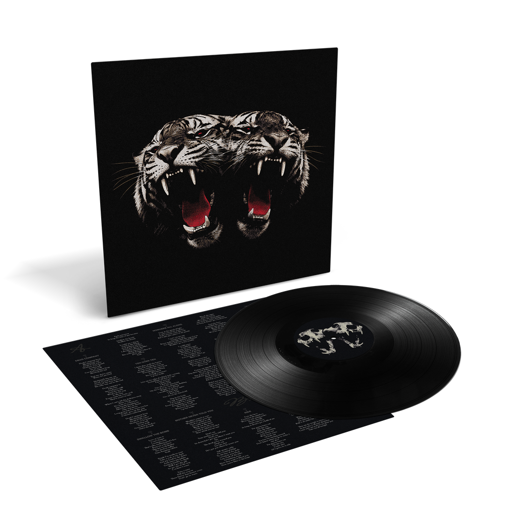 A vinyl record package shown on a clean white background: a black square album cover featuring a large roaring tiger head, with the black record partially pulled from the inner sleeve and printed tracklist visible.